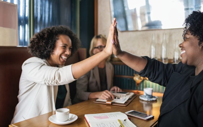 Succesful businesswomen giving a high five